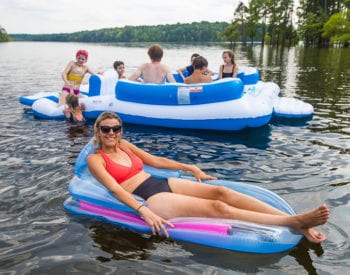 woman in a blue floatie floating on the lake
