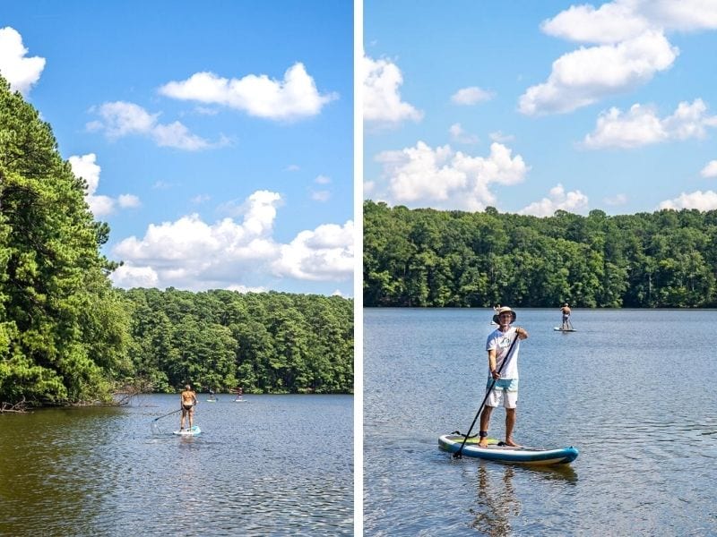 A man stand up paddle boarding on a lake