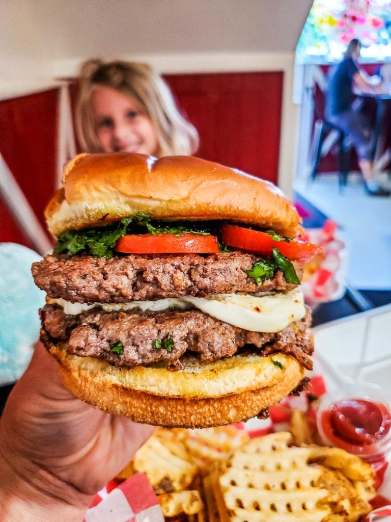 hand holding up a burger