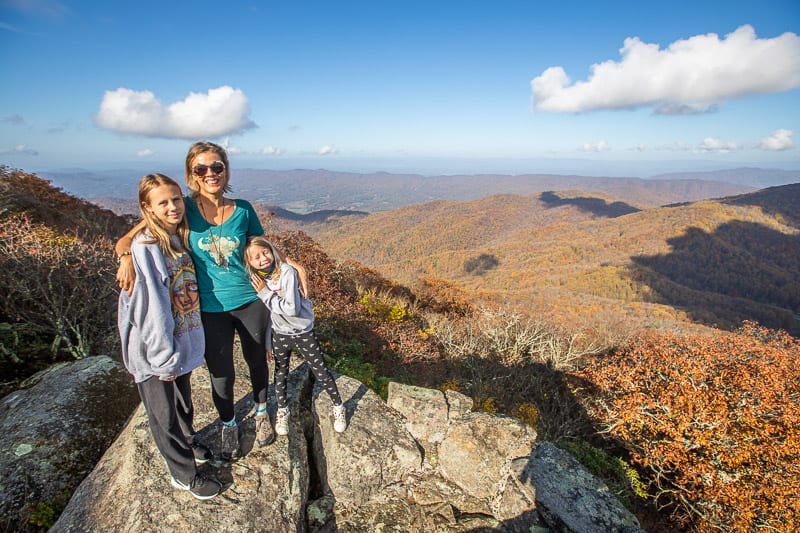 woman and two girls overlooking the mountains  from Peaks of Otter, Virgina