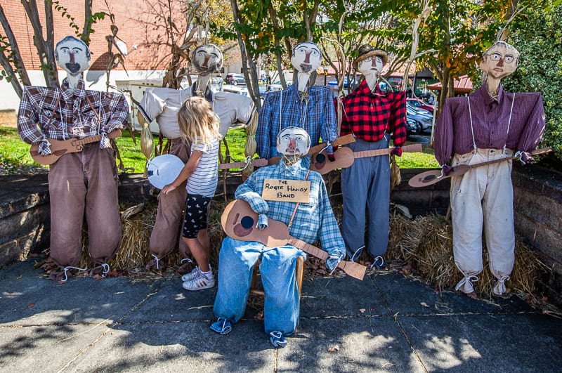 scarecrows sitting on a bench