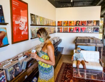 woman looking through vinyls in record store