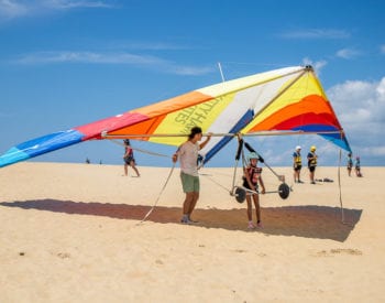 A man flying a kite on the beach
