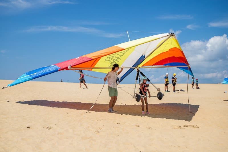 A man flying a kite on the beach