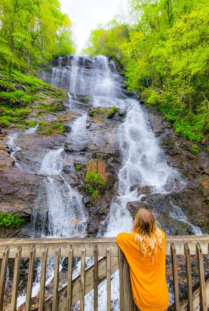 A girl looking at a waterfall