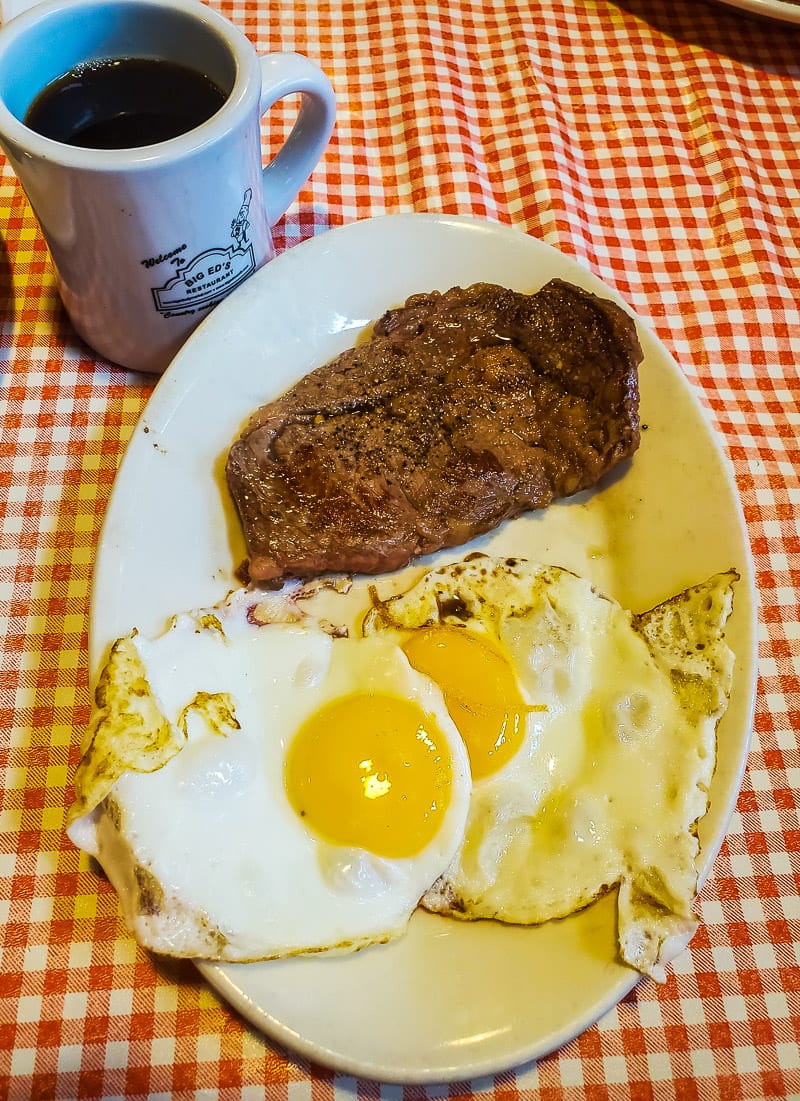 plate of eggs and steak with coffee
