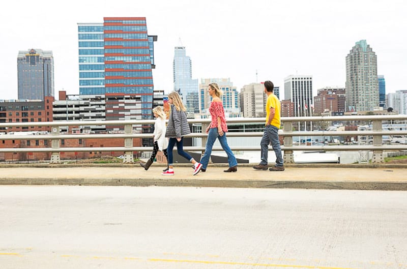 family walking across a bridge