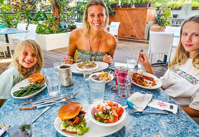 women and girls enjoying greek dinner at table