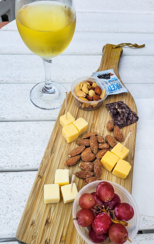 charcuterie board and wine glass on table