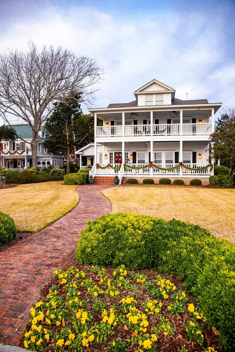 white historic home with sweeping lawn