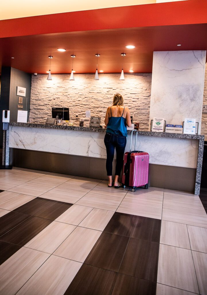 a woman checking into a hotel 