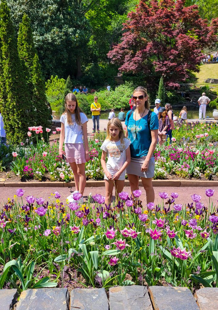 People standing in front of a flower garden