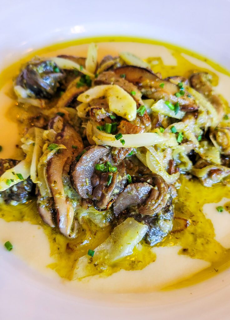 A plate of snails and mushroom  Coquette Restaurant