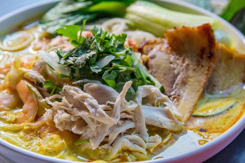 A close up of a bowl of curry laksa