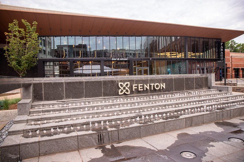 A bench in front of a building with fenton cary sign