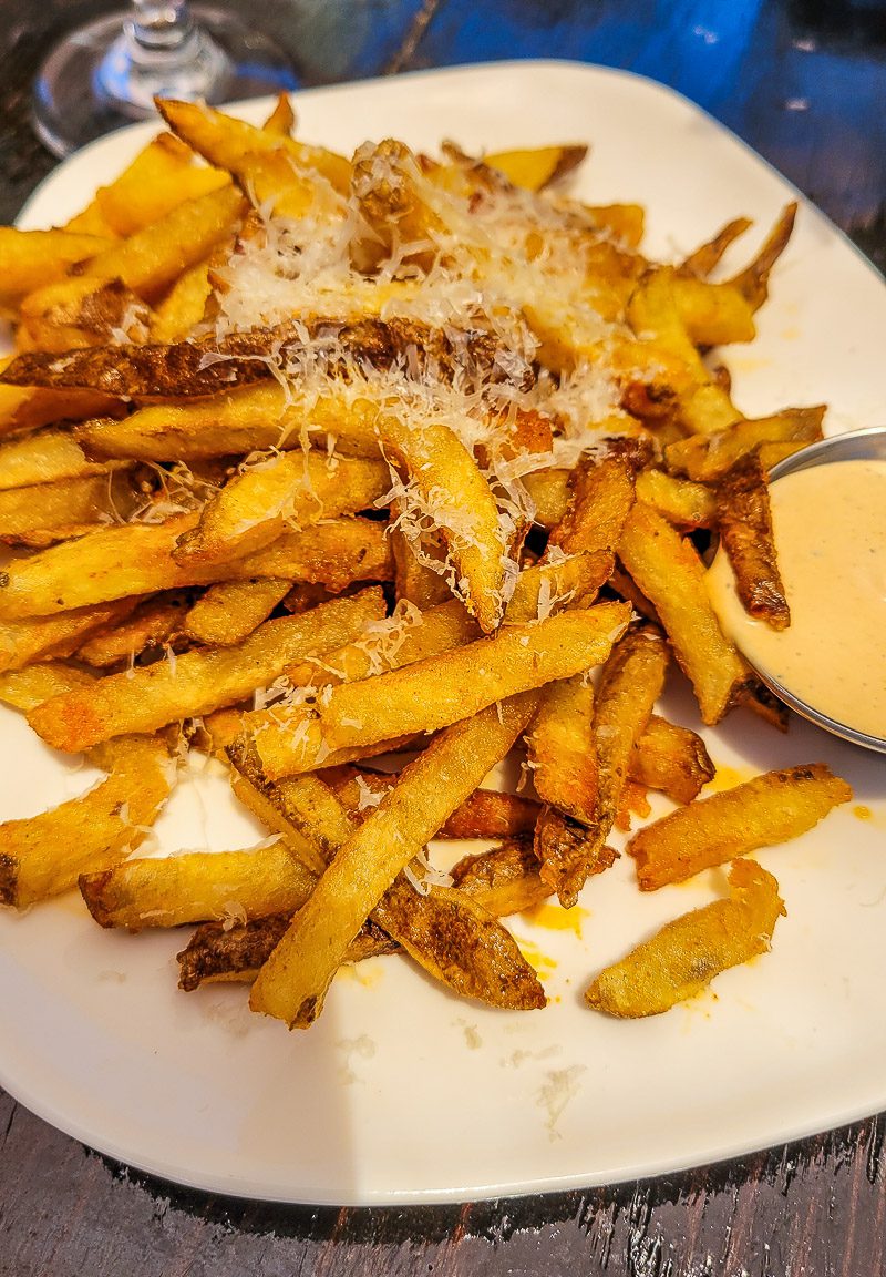 a plate of fries with cheese on top  smokestack cafe raleigh