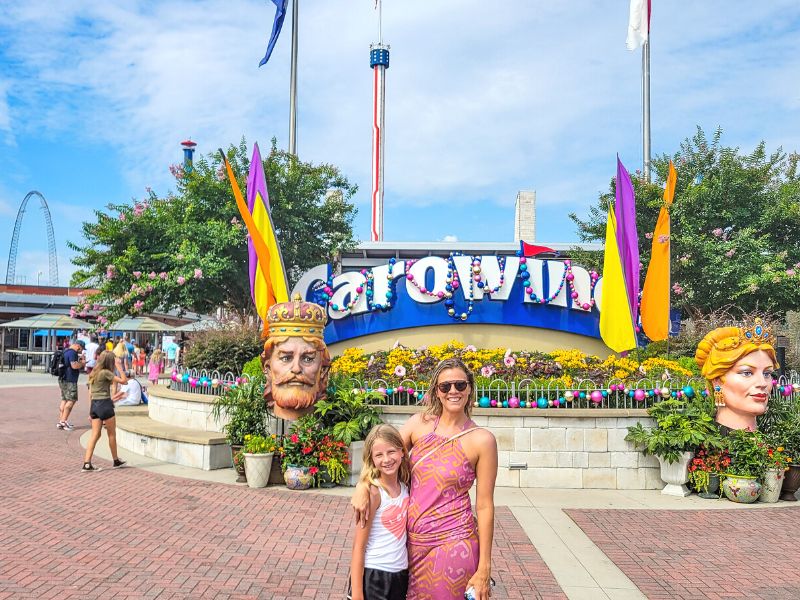 Mother and daughter in front of entrance sign at Carowinds Amusement Park