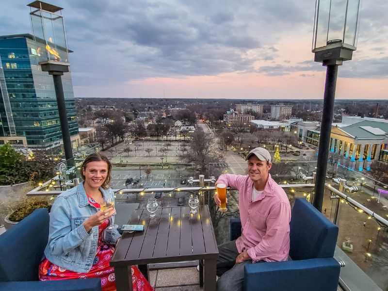 A couple enjoying a drink on a rooftop bar