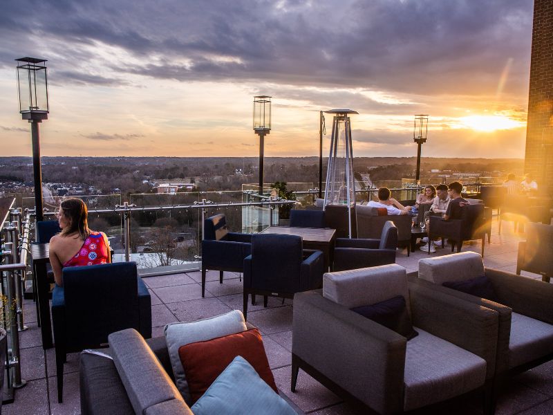 People enjoying a sunset drink on a rooftop bar