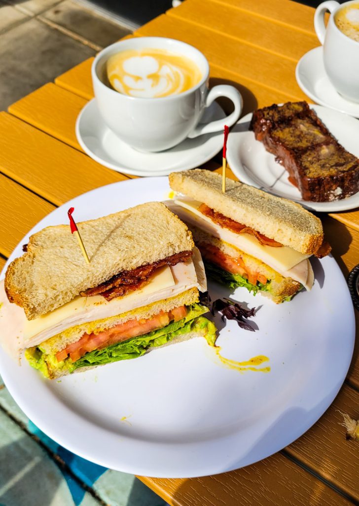 Cup of coffee and sandwiches on a plate