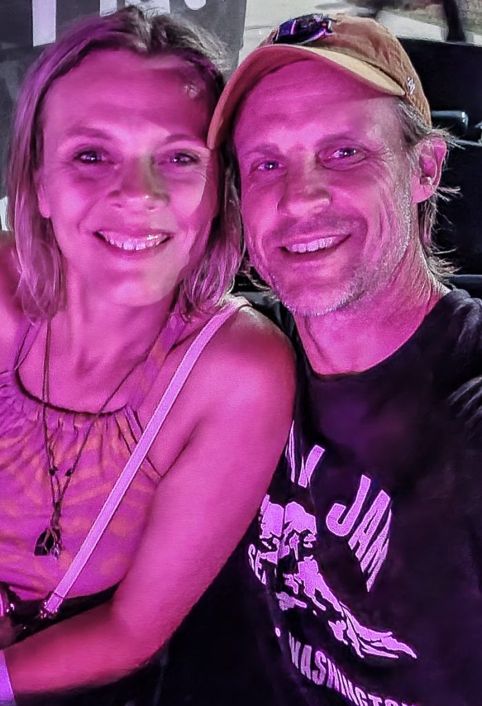 photo of a couple smiling at a concert