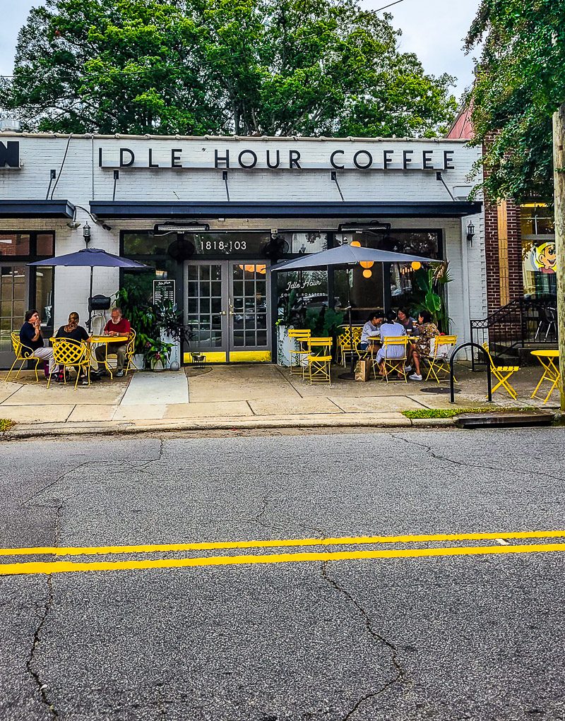 People sitting on table and chairs out the front of a coffee shop - Idle Hour Coffee Shop, Raleigh