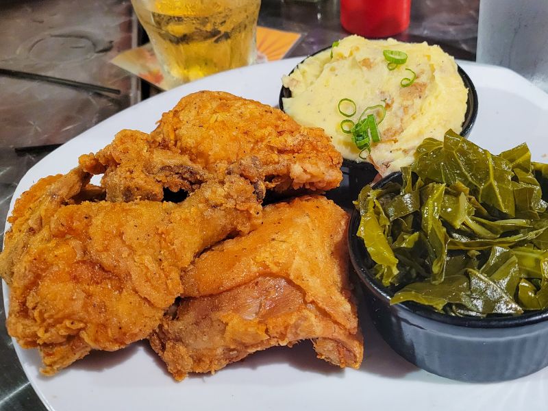 Fried chicken with mashed potato and collard greens