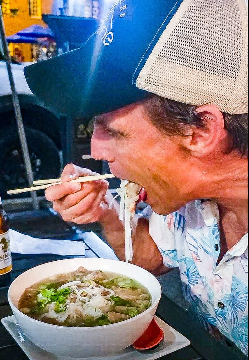 Man eating a bowl of noodle soup