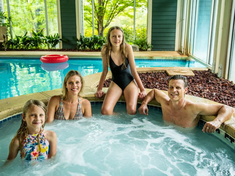 Family of 4 soaking in a hot tub at Brasstown Valley Resort