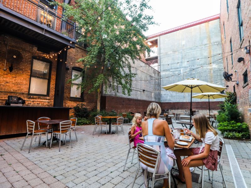 Mother and daughters dining in a courtyard at Gravy, Raleigh