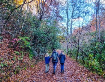 Mother and two daughters on a hiking trail during Fall in the Great Smoky Mountains