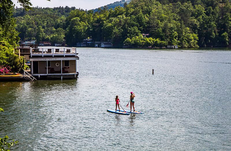 Mother and daughter paddle boarding on a lake