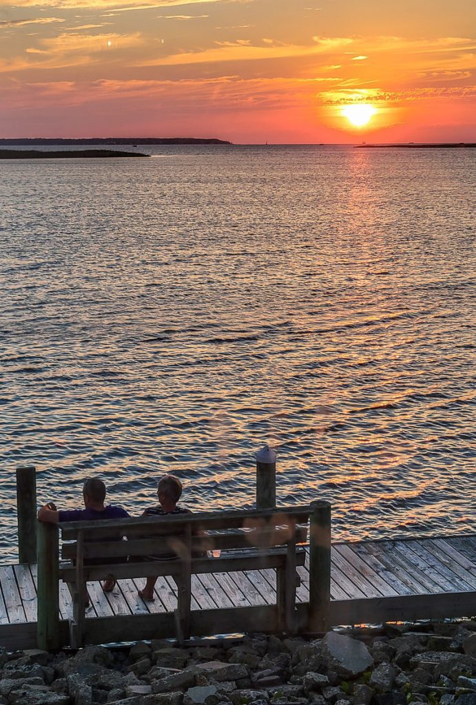 Couple watching a sunset over the water - Outer Banks