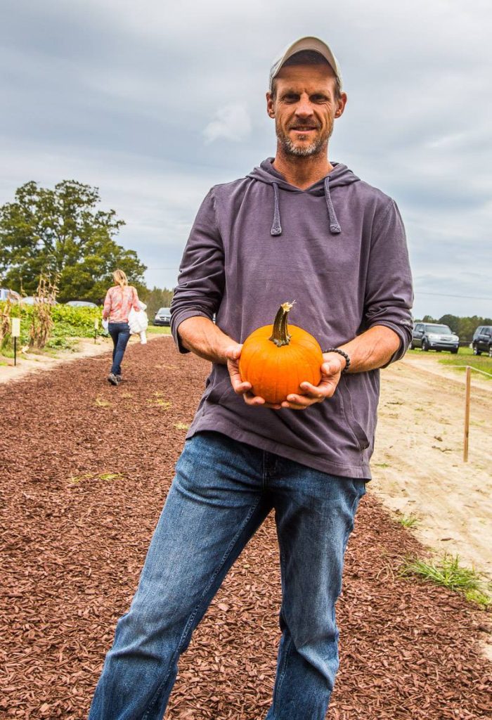man holding smal pumpkin