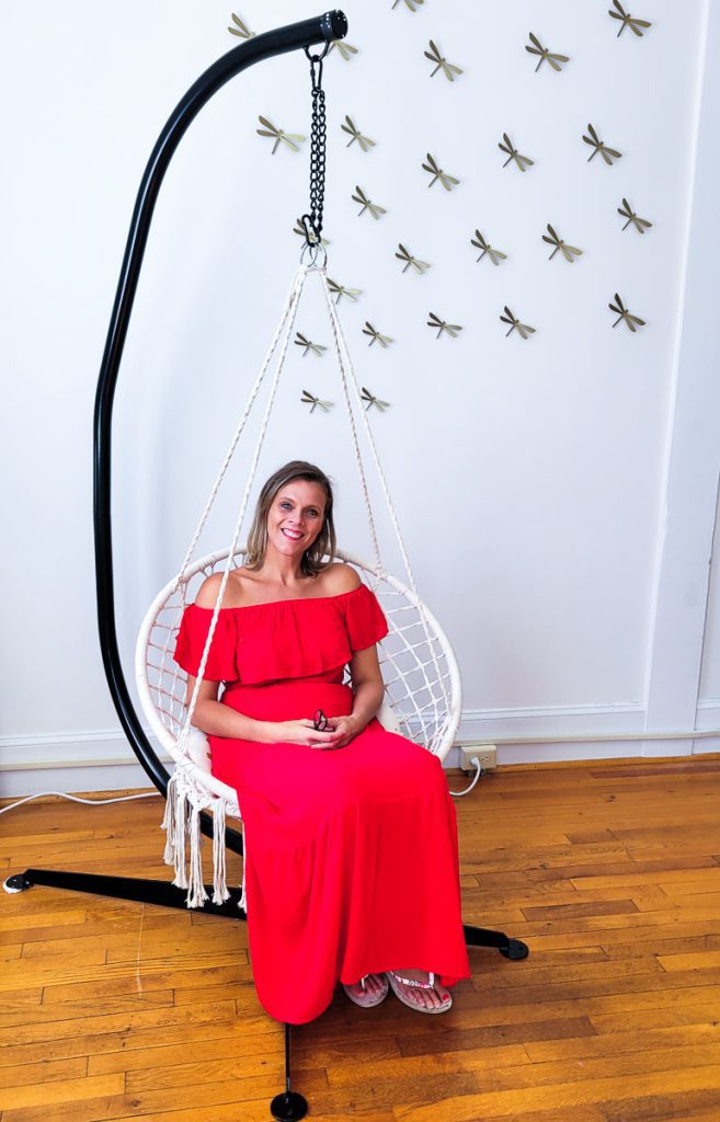 A woman sitting in aswinging chair
