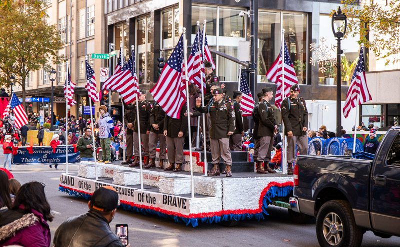 Group of military personel on a parade float