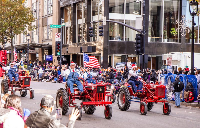 Men on tractors in a parade
