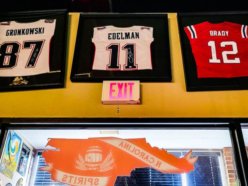 Three NFL jerseys hanging up in a bar