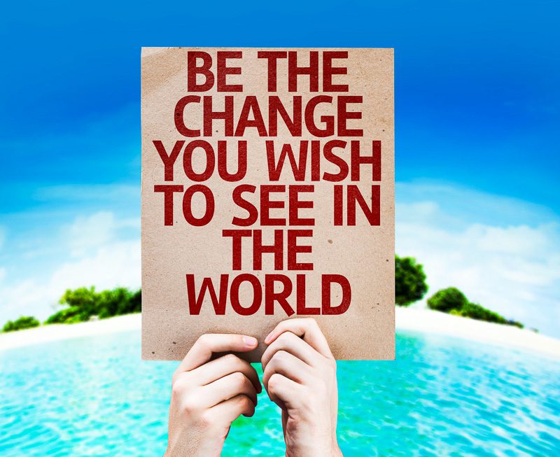 Be The Change You Wish to See in the World card with a beach on background