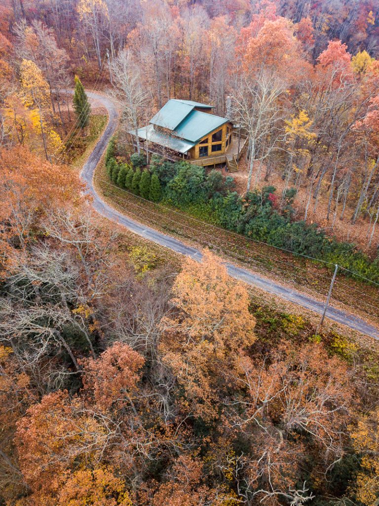 cabin in the mountains surrounded by fall foliage