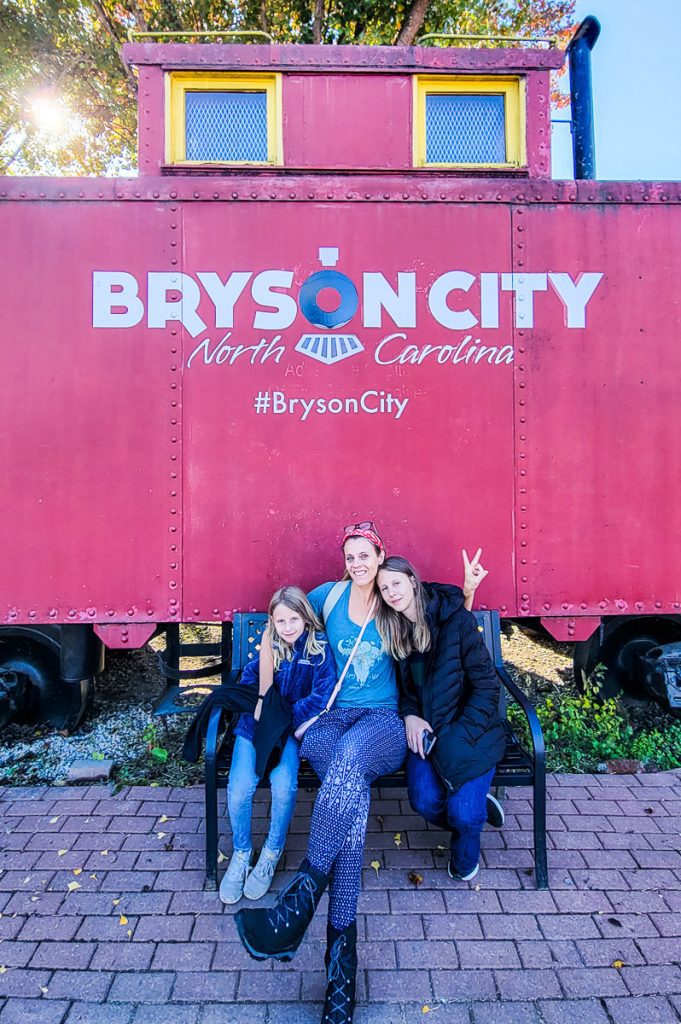 family posing in front of Bryson City sign