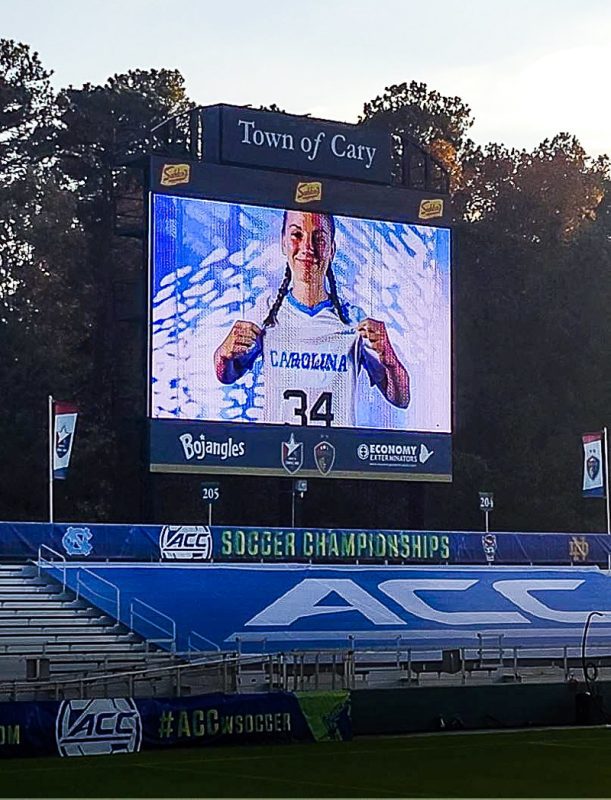 Girl soccer player on a video screen at a stadium