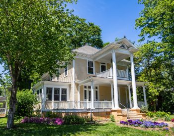 Southern home with a front porch and flower garden