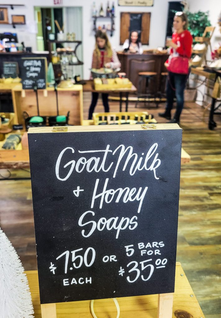 A sign saying goat milk + honey for sale