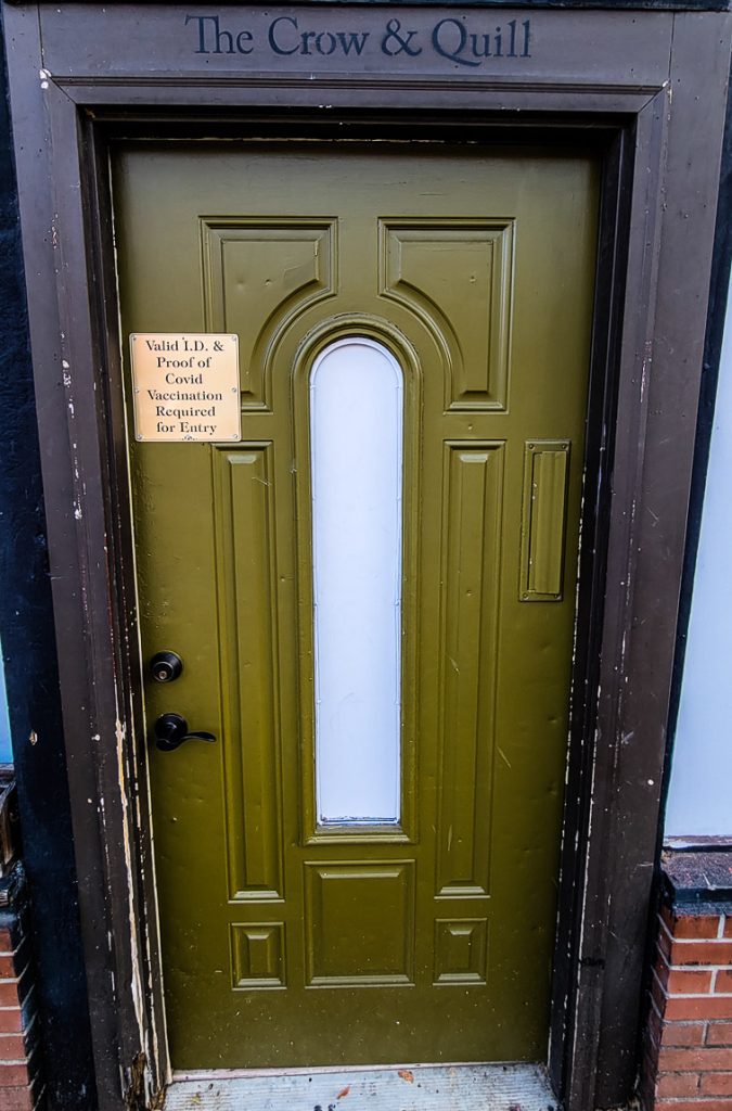 Green entrance door to a bar