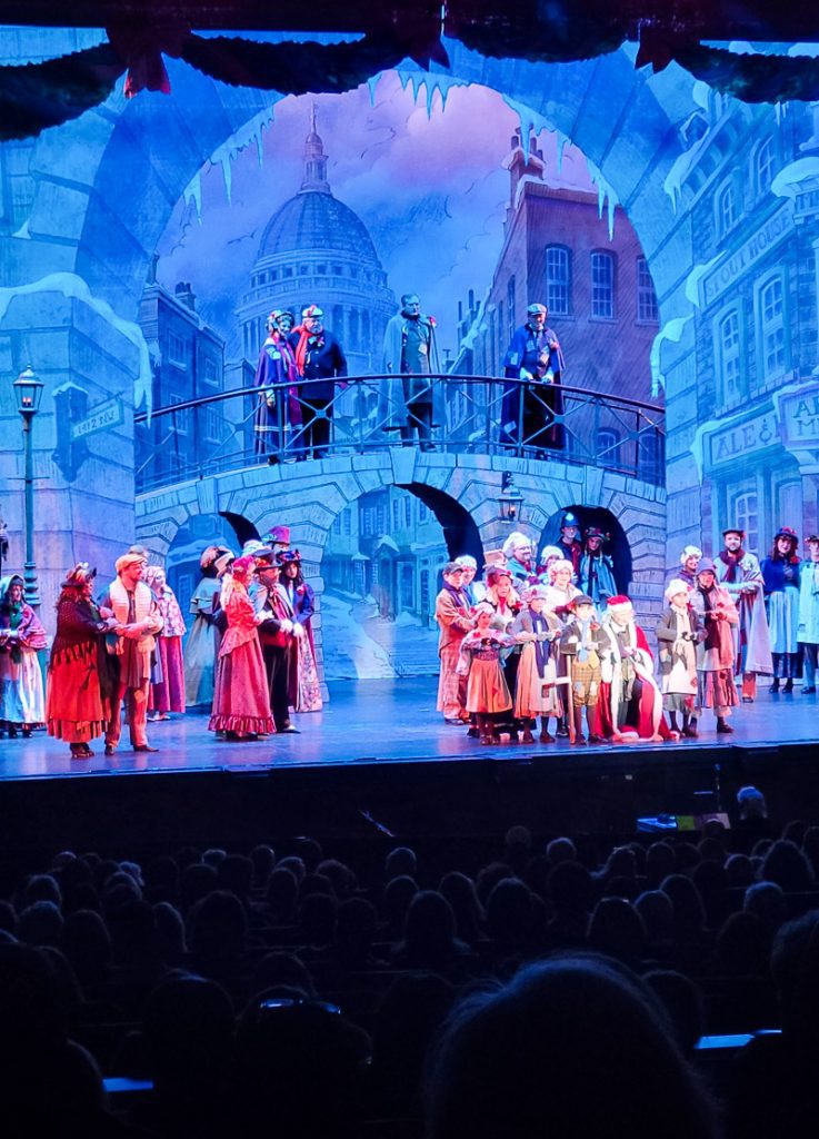 Performers on stage performing the play A Christmas Carol
