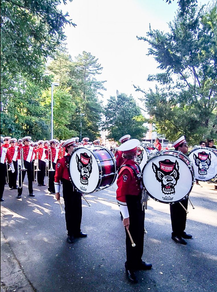 Marching band dressed in red at a college football game