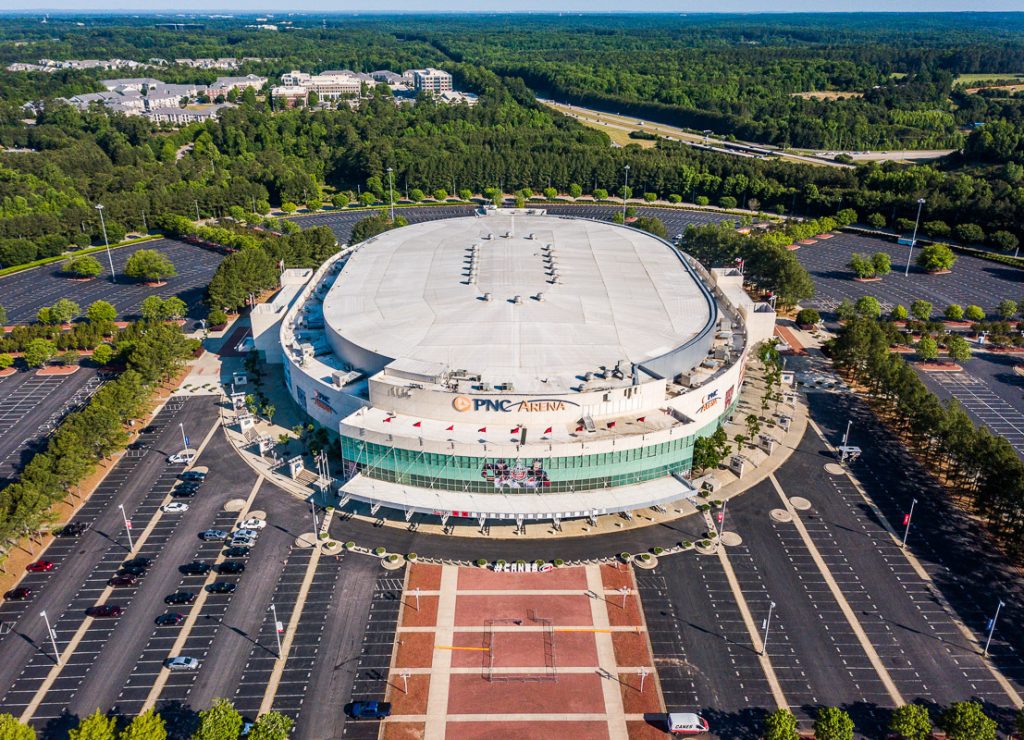 Aerial view of an dome ice hockey stadium and empty carpark