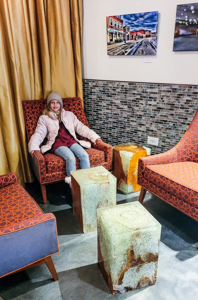 Young girl sitting in a chair in a hotel lobby