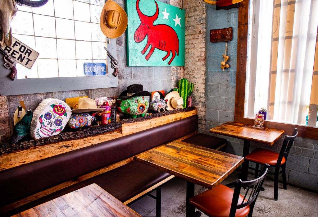 Indoor dining tables and artwork at a Mexican restaurant